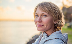 woman smiling by lake