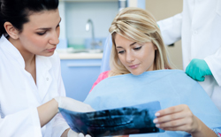 Dentist and patient looking at x-rays