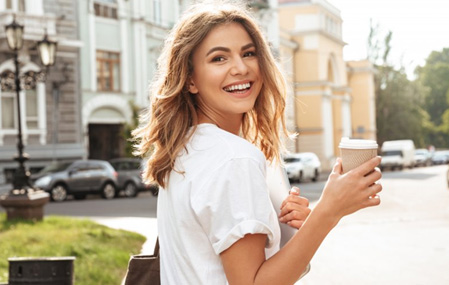 Woman enjoying the town and looking back at the camera as she smiles
