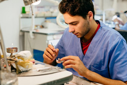Lab technician customizing a dental crown