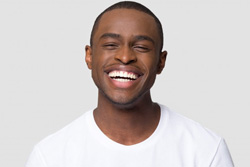 Man smiling brightly on a white background