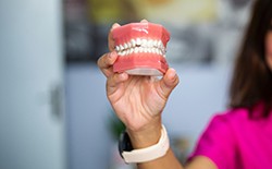 Woman holding set of denture mold