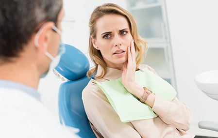 Female patient with toothache visiting emergency dentist in Texarkana, TX