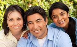 family of three smiling