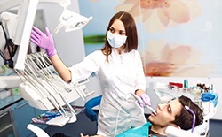 Dentist showing man in dental chair his images of smile