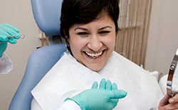 woman laughing in exam chair