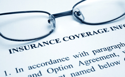 Glasses on top of an insurance coverage information sheet