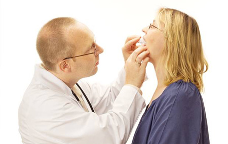 Dentist checking the fit of a sleep apnea appliance