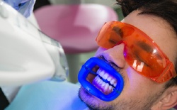 Man receiving in-office teeth whitening treatment