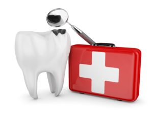 Damaged tooth next to dental mirror and emergency kit
